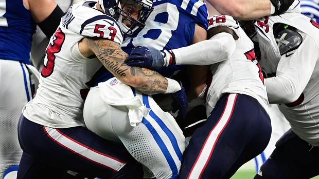 Texans linebacker Blake Cashman grimaces as he helps to tackle Indianapolis Colts running back Jonathan Taylor (28) during the second half at Lucas Oil Stadium.