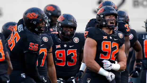 Nov 12, 2022; Stillwater, Oklahoma, USA; Oklahoma State Cowboys defensive end Nathan Latu (92) celebrates after making a fumble recovery against the Iowa State Cyclones in the third quarter at Boone Pickens Stadium. OSU won 20-14. Mandatory Credit: Sarah Phipps-USA TODAY Sports