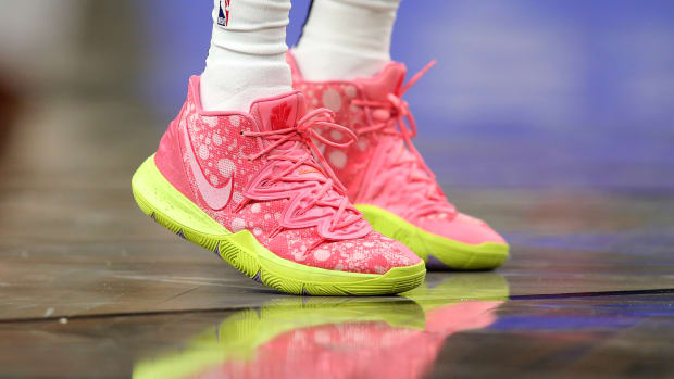 View of pink and yellow Nike Kyrie shoes.