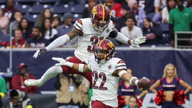 Washington Commanders safeties Darrick Forrest (22) and Kamren Curl (31) celebrate after a turnover against the Houston Texans.