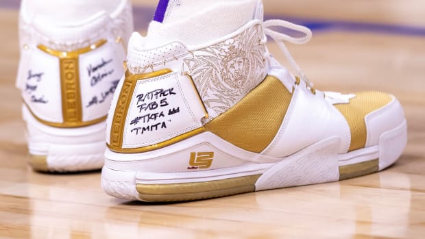 View of LeBron James' white and gold Nike shoes.