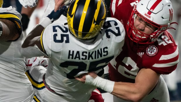 Nick Henrich tackles Hassan Haskins 2Q 2021 Michigan USATSI_16926474