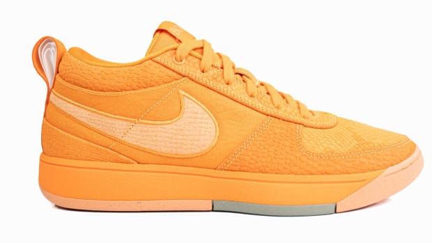Side view of Devin Booker's orange Nike sneakers.