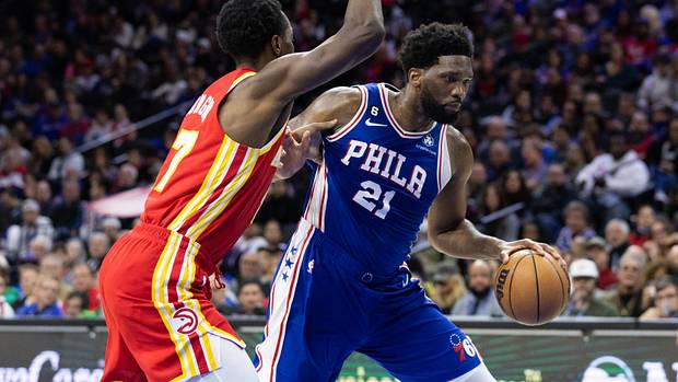 76ers center Joel Embiid dribbles past Hawks forward Onyeka Okongwu.