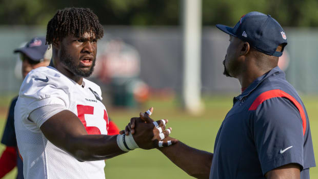 Houston Texans defensive end Will Anderson Jr. (51) shakes hands with a coach during training camp at the Houston Methodist Training Center.