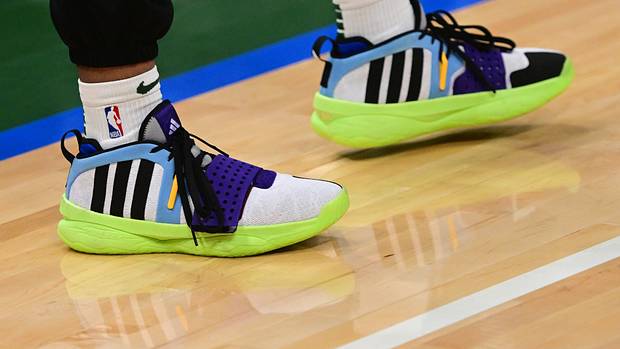 Milwaukee Bucks guard Damian Lillard's black and green adidas shoes.