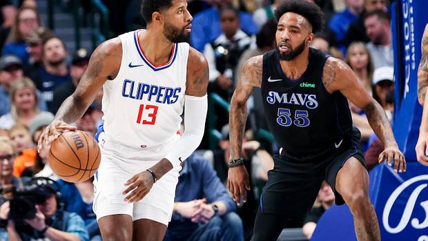 Mavs' Derrick Jones Jr. defends Clippers' Paul George in the post.