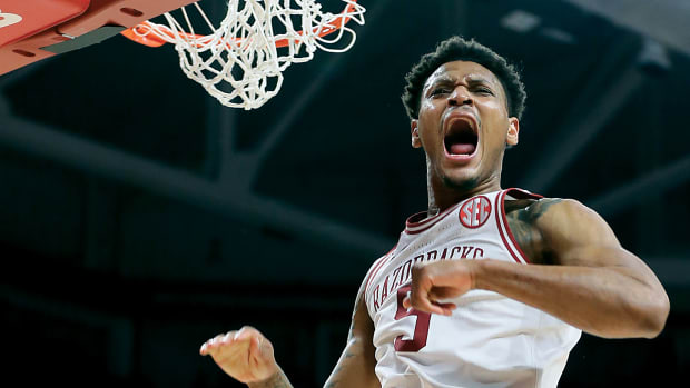Arkansas Razorbacks guard Au'Diese Toney (5) celebrates after dunking the ball in the second half against the West Virginia Mountaineers at Bud Walton Arena. Arkansas won 77-68.