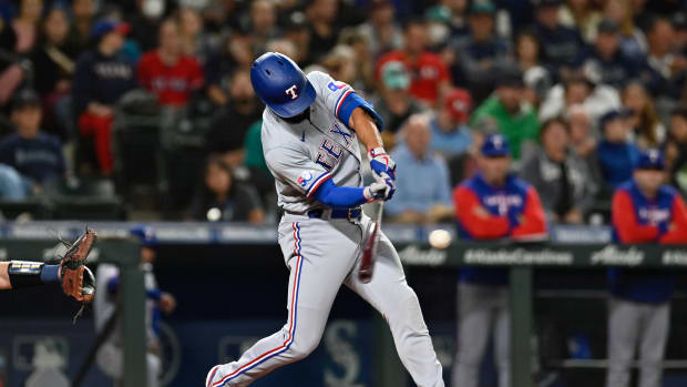 Sep 29, 2022; Seattle, Washington, USA; Texas Rangers second baseman Marcus Semien (2) hits a two run home run against the Seattle Mariners during the third inning at T-Mobile Park. Mandatory Credit: Steven Bisig-USA TODAY Sports