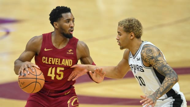 Jan 7, 2024; Cleveland, Ohio, USA; Cleveland Cavaliers guard Donovan Mitchell (45) dribbles beside San Antonio Spurs forward Jeremy Sochan (10) in the first quarter at Rocket Mortgage FieldHouse. Mandatory Credit: David Richard-USA TODAY Sports