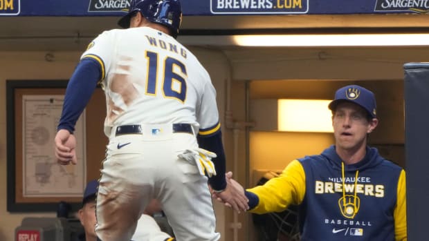Craig Counsell and Kolten Wong celebrate as members of the Milwaukee Brewers