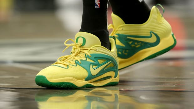 View of yellow and green Nike KD shoes.