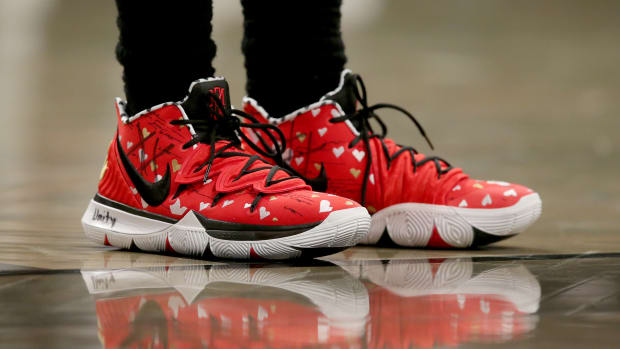 View of Kyrie Irving's red and black Nike shoes.