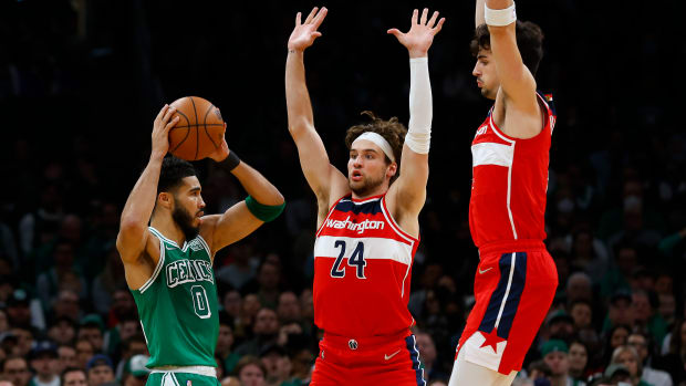Boston Celtics forward Jayson Tatum looks for an opening around Washington Wizards forward Corey Kispert and Deni Avdija