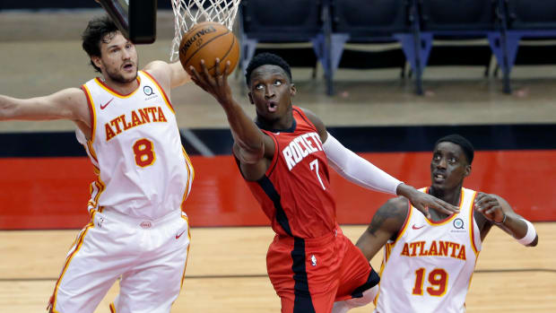 Rockets guard Victor Oladipo puts up a shot between Atlanta Hawks forward Danilo Gallinari and Atlanta Hawks guard Tony Snell.