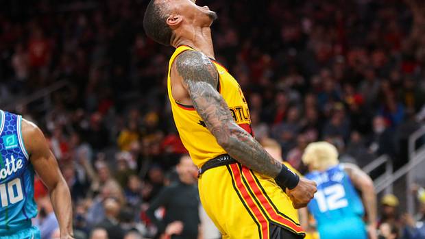 Hawks forward John Collins celebrates after a dunk.