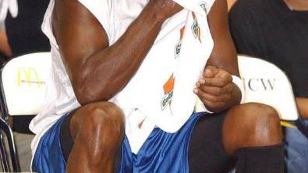 Michael Jordan sits on the bench during a scrimmage.
