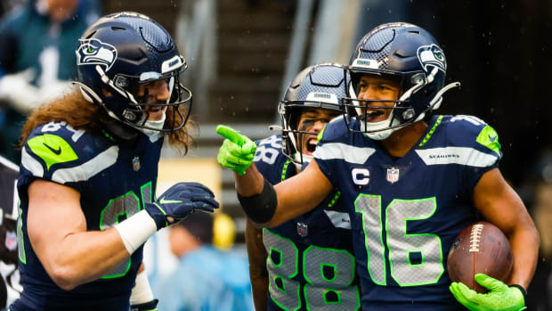 Seattle Seahawks wide receiver Tyler Lockett (16) celebrates with tight end Colby Parkinson (84) and wide receiver Cade Johnson (88) after catching a touchdown pass against the Los Angeles Rams during the third quarter at Lumen Field.