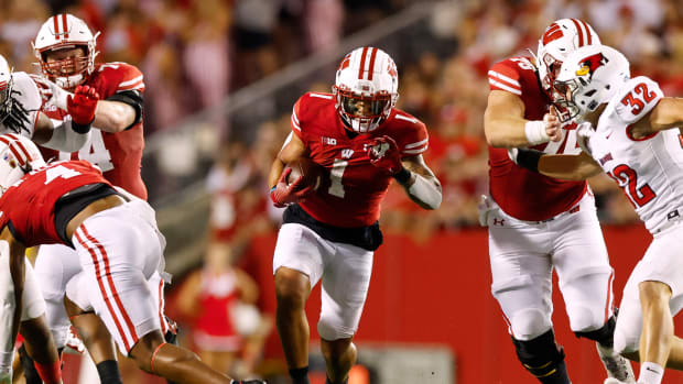 Wisconsin running back Chez Mellusi running through an open hole in the Illinois State defense