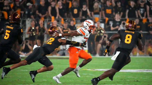 Oklahoma State Cowboys running back Jaden Nixon (3) carries the ball against Arizona State Sun Devils linebacker Caleb McCullough (22) in the first half at Mountain America Stadium in Tempe on Sept. 9, 2023.