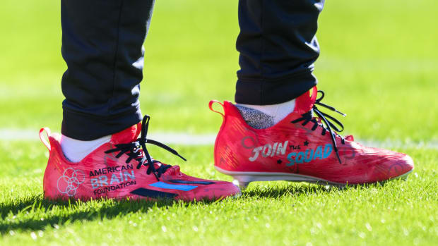View of red and black cleats.