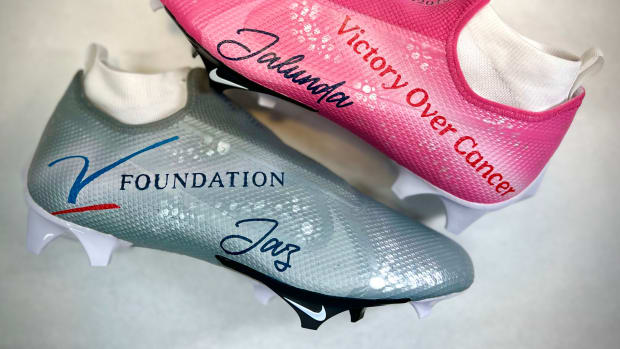 View of silver and pink custom cleats.