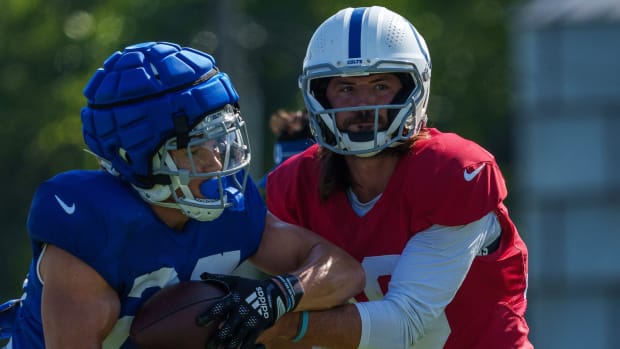 Indianapolis Colts quarterback Gardner Minshew (10) hands off to Indianapolis Colts running back Evan Hull (26) on Monday, July 31, 2023, during training camp at the Grand Park Sports Campus in Westfield, Indiana.