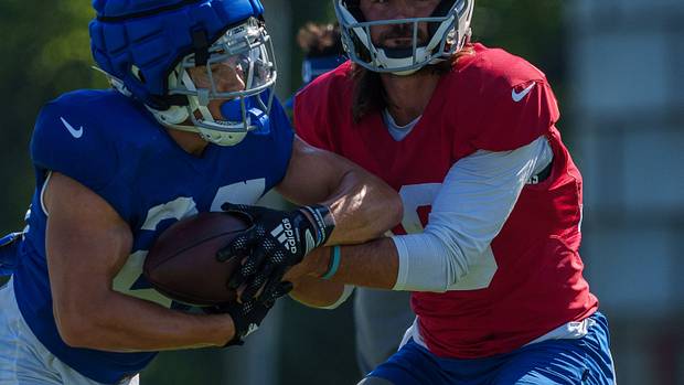 Indianapolis Colts quarterback Gardner Minshew (10) hands off to Indianapolis Colts running back Evan Hull (26) on Monday, July 31, 2023, during training camp at the Grand Park Sports Campus in Westfield, Indiana.