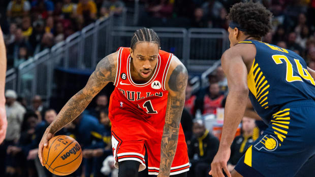Jan 24, 2023; Indianapolis, Indiana, USA; Chicago Bulls forward DeMar DeRozan (11) dribbles the ball while Indiana Pacers guard Buddy Hield (24) defends in the second half at Gainbridge Fieldhouse.