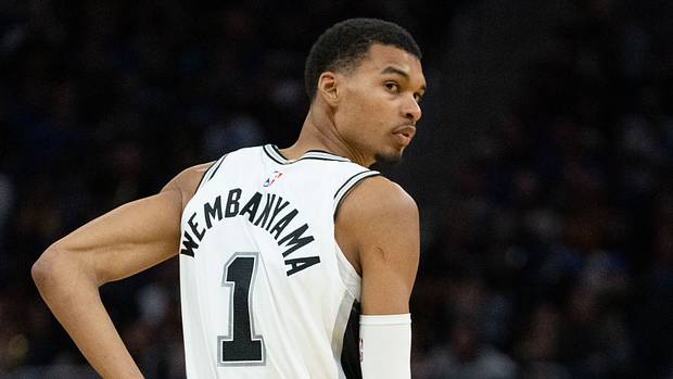 San Antonio Spurs center Victor Wembanyama looks back at a teammate during a game.