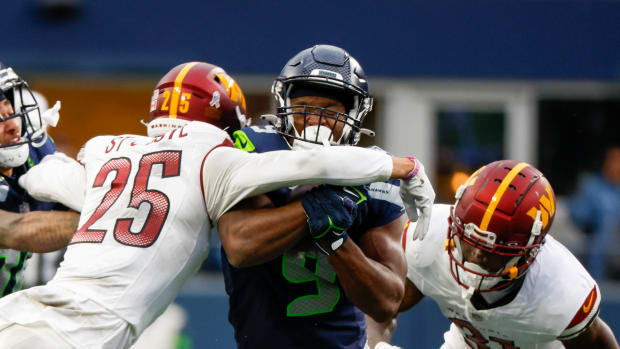 Seattle Seahawks running back Kenneth Walker III (9) rushes against the Washington Commanders during the second quarter at Lumen Field.