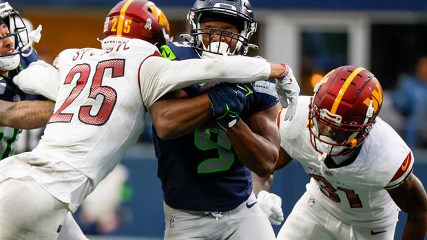 Seattle Seahawks running back Kenneth Walker III (9) rushes against the Washington Commanders during the second quarter at Lumen Field.