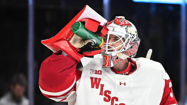 Wisconsin goaltender Kyle McClellan (31) takes a drink during a stoppage during the third period of the championship game of the Kwik Trip Holiday Face-Off against Northeastern on Friday, December 29, 2023, at Fiserv Forum in Milwaukee, Wisconsin.  