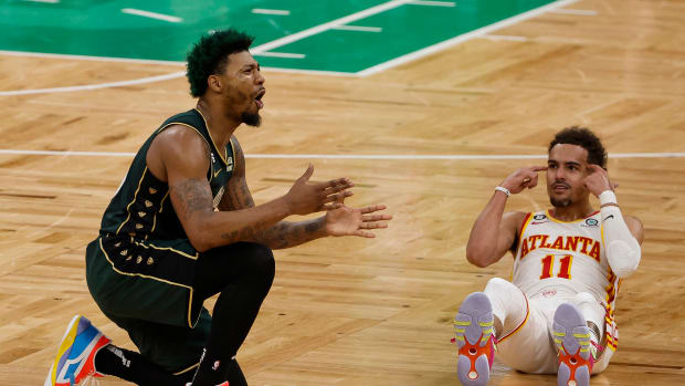 Boston Celtics guard Marcus Smart and Atlanta Hawks guard Trae Young react to a foul call.