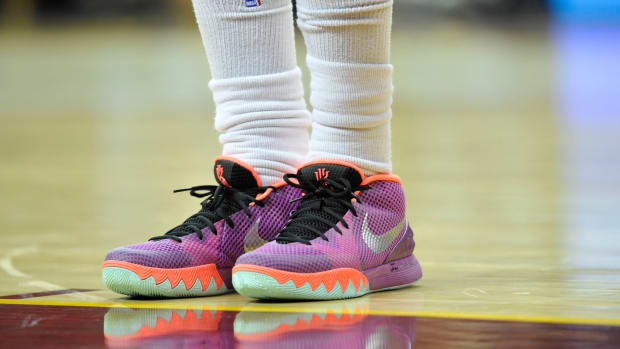 View of Kyrie Irving's purple and orange Nike shoes.