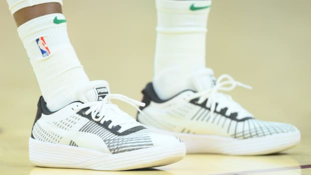 View of Dennis Schroder's white and black Puma basketball shoes.