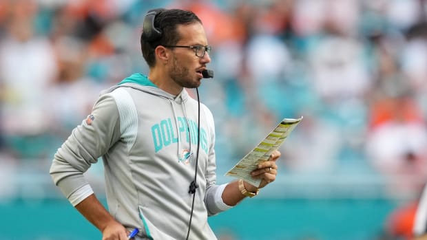 Dolphins coach Mike McDaniel looks over his play sheet during a game.