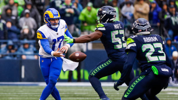Los Angeles Rams quarterback Baker Mayfield (17) shovel passes as Seattle Seahawks linebacker Boye Mafe applies pressure during the second quarter at Lumen Field.