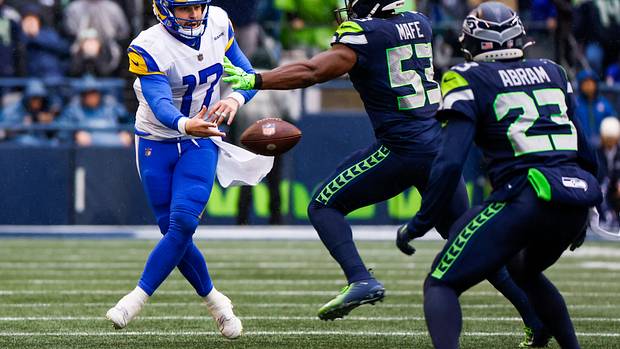 Los Angeles Rams quarterback Baker Mayfield (17) shovel passes as Seattle Seahawks linebacker Boye Mafe applies pressure during the second quarter at Lumen Field.