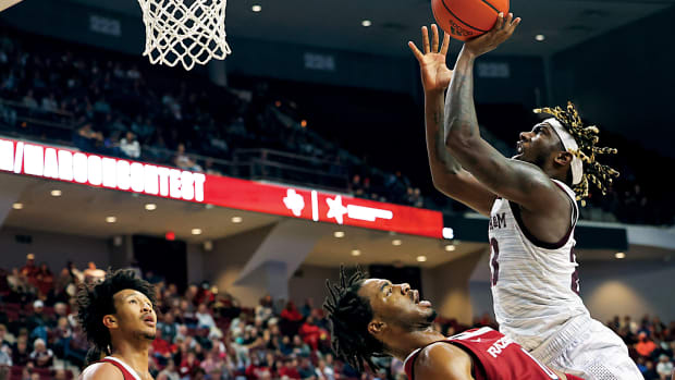 Arkansas Razorbacks guard Stanley Umude (0) is called for a foul against Texas A&M Aggies guard Tyrece Radford (23) the second half at Reed Arena. Texas A&M won, 86-81.