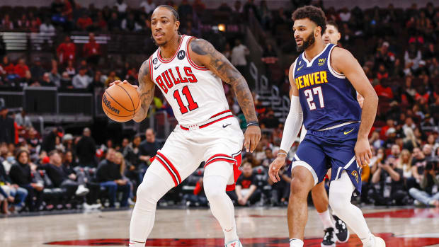 Oct 7, 2022; Chicago, Illinois, USA; Chicago Bulls forward DeMar DeRozan (11) drives to the basket past Denver Nuggets guard Jamal Murray (27) during the first half at United Center.