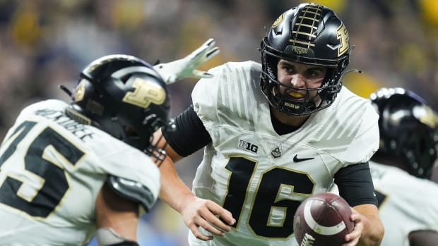 Purdue Boilermakers quarterback Aidan O'Connell (16) hands off the ball to Purdue Boilermakers running back Devin Mockobee (45) during the Big Ten football championship on Saturday, Dec. 3, 2022 at Lucas Oil Stadium in Indianapolis. Michigan Wolverines defeated the Purdue Boilermakers, 43-22.