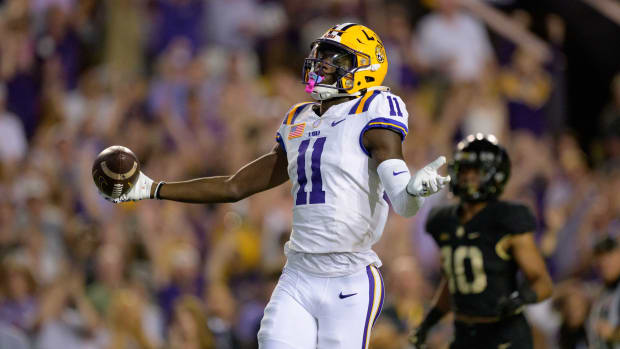 Oct 21, 2023; Baton Rouge, Louisiana, USA; LSU Tigers wide receiver Brian Thomas Jr. (11) celebrates a touchdown against Army Black Knights defensive back Cameron Jones (10) during the first quarter at Tiger Stadium. Mandatory Credit: Matthew Hinton-USA TODAY Sports  