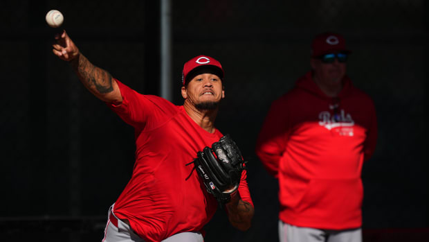 Cincinnati Reds starting pitcher Frankie Montas (47) throws in the bullpen as Cincinnati Reds pitching coach Derek Johnson observes during spring training workouts, Wednesday, Feb. 14, 2024, at the team s spring training facility in Goodyear, Ariz.  