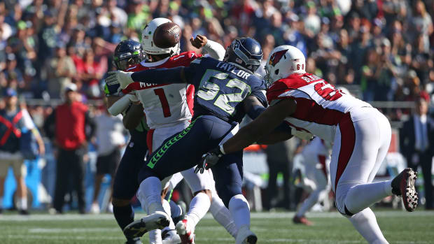 SEATTLE, WASHINGTON - OCTOBER 16: Darrell Taylor #52 of the Seattle Seahawks forces a fumble against Kyler Murray #1 of the Arizona Cardinals during the second quarter at Lumen Field on October 16, 2022 in Seattle, Washington.