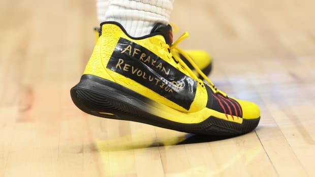 View of Kyrie Irving's yellow and black Nike shoes.