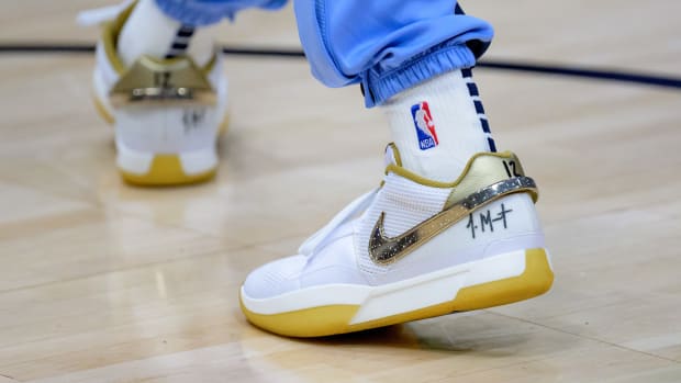 Memphis Grizzlies guard Ja Morant's white and gold Nike sneakers.