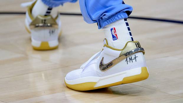 Memphis Grizzlies guard Ja Morant's white and gold Nike sneakers.