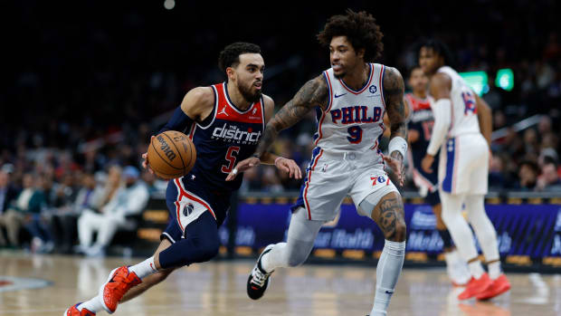 Washington Wizards guard Tyus Jones (5) drives to the basket as Philadelphia 76ers guard Kelly Oubre Jr. (9) defends in the second half at Capital One Arena. Mandatory Credit: Geoff Burke-USA TODAY Sports