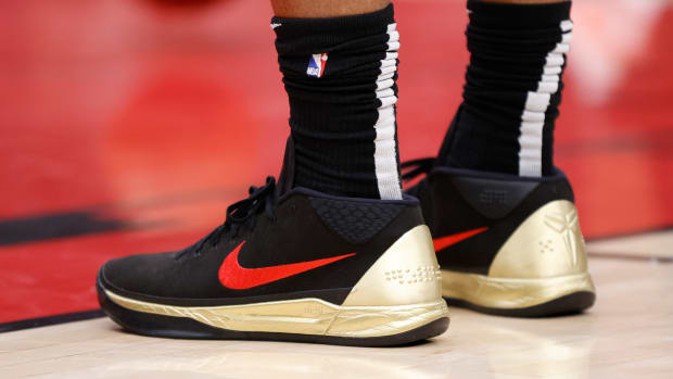 View of black, red, and gold Nike Kobe shoes.